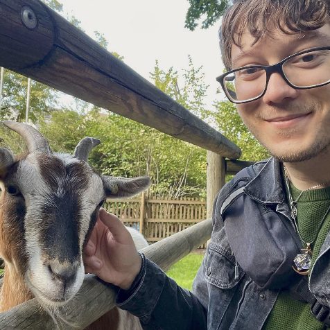 graduate student Nicholas Gonzalez photo with a goat