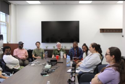 Grad students around a table having a conversation